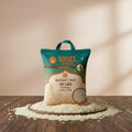 A 10 lb bag of Rigel Spices Basmati Rice on a plain white background. The packaging features a teal top section with orange branding and a beige lower section with an illustration of a temple and a circular inset showing the raw rice grains.